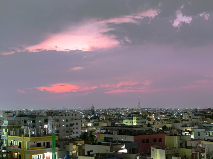 City skyline at dusk with pink-streaked clouds
