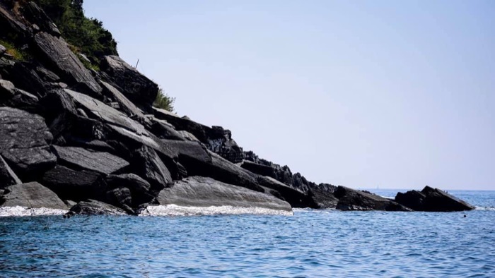 Rocky coastal cliffs meeting the sea