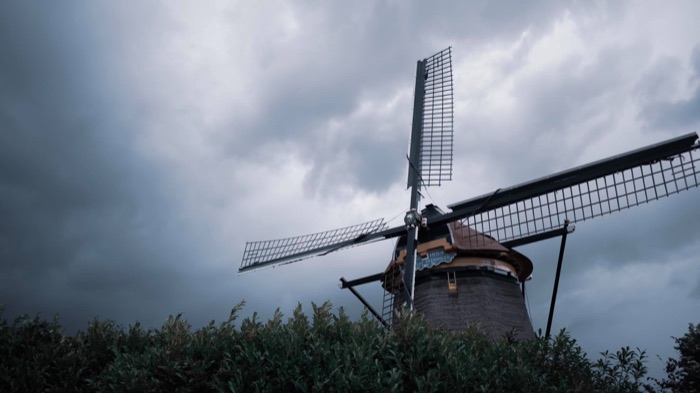 Traditional windmill against a dramatic stormy sky