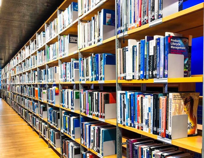 Long rows of bookshelves in a university library