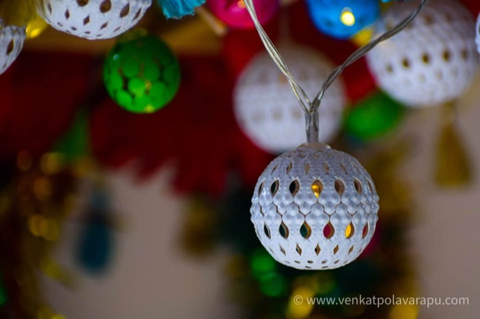 Decorative string lights and ornaments with warm bokeh